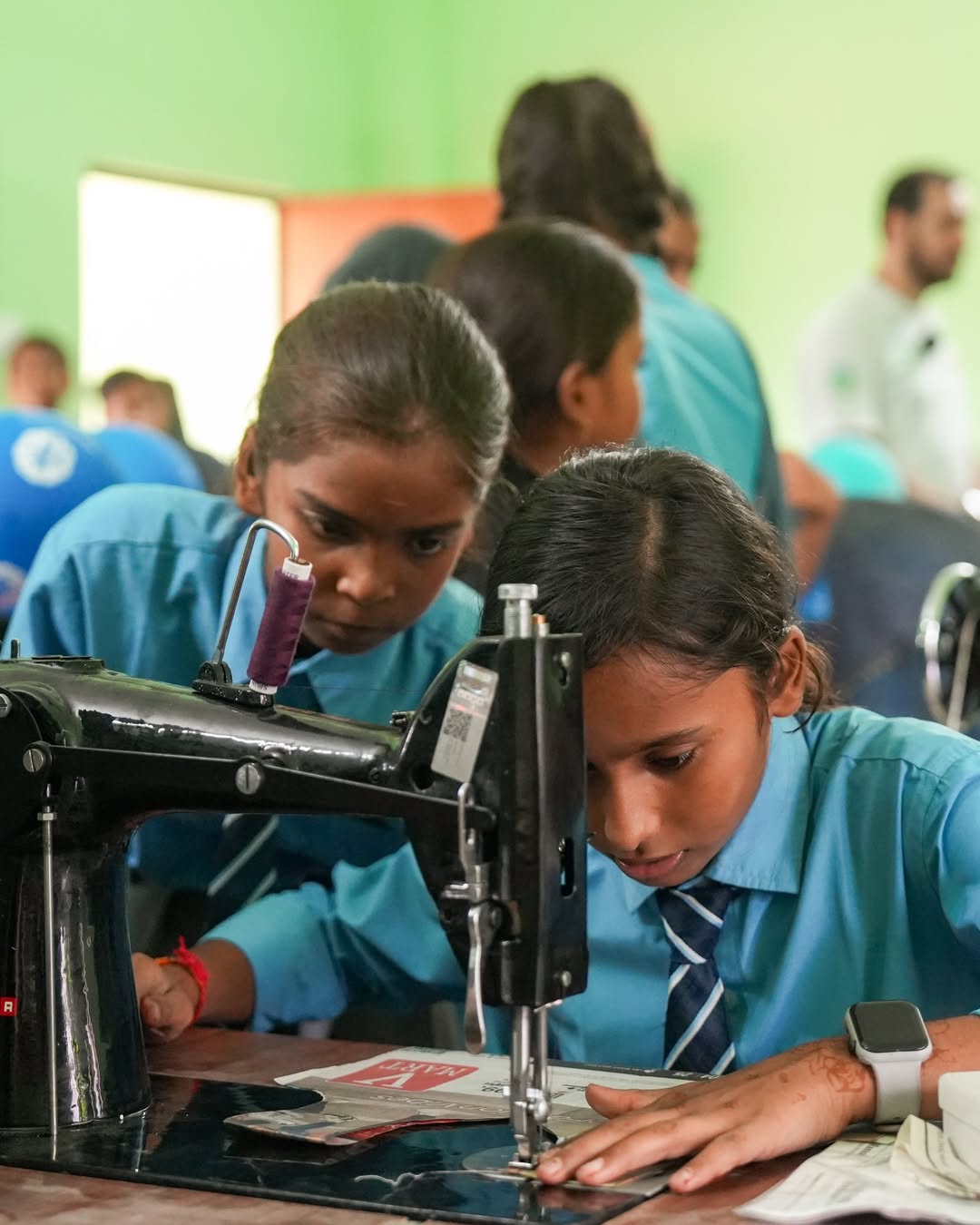 Students learning sewing and practical skills at Blue Ink School International